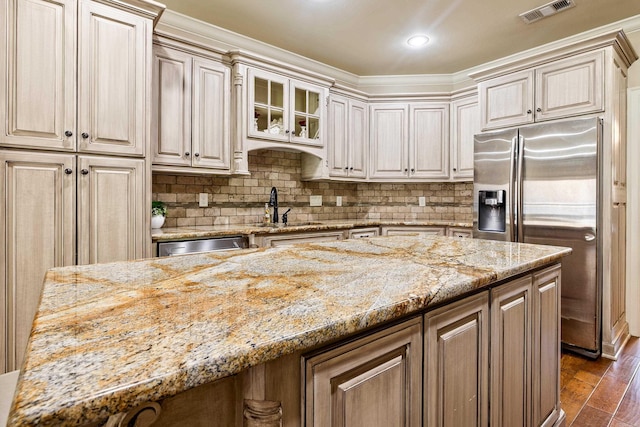 14 Longwell Loop, Little Rock, AR 72211 - kitchen with stainless steel fridge with ice dispenser, light stone countertops, dark wood finished floors, tasteful backsplash, and glass insert cabinets