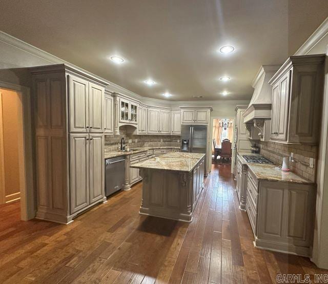 14 Longwell Loop, Little Rock, AR 72211 - kitchen featuring appliances with stainless steel finishes, dark wood finished floors, light stone countertops, tasteful backsplash, and crown molding