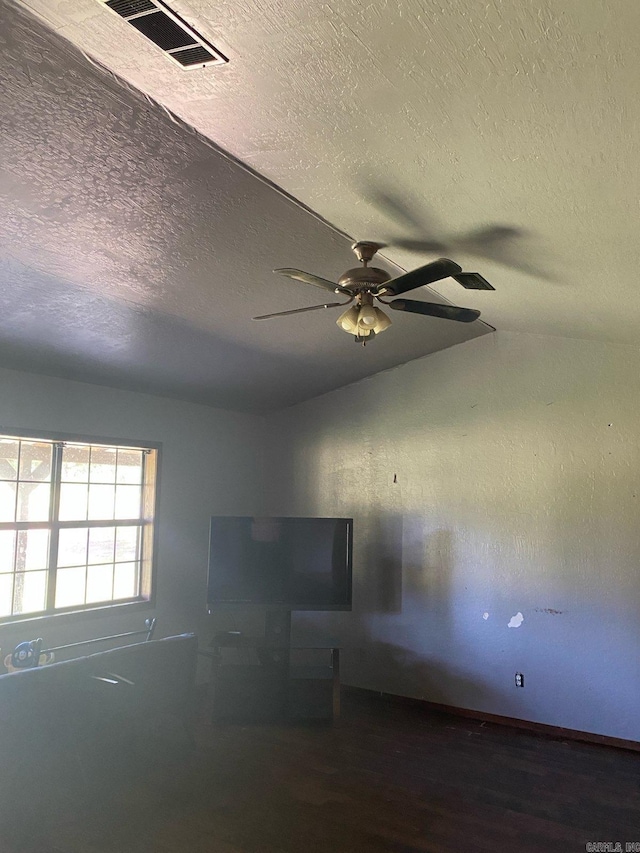 564 Polk Road 74, Mena, AR 71953 - unfurnished room with a textured ceiling, a ceiling fan, lofted ceiling, and wood finished floors