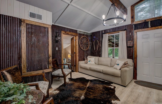 164 Roxie Ln, Greers Ferry, AR 72067 - living room with wood walls, a chandelier, and light wood-style flooring