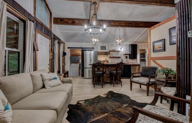 164 Roxie Ln, Greers Ferry, AR 72067 - living area featuring a barn door, light wood finished floors, a chandelier, and beam ceiling