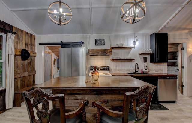 164 Roxie Ln, Greers Ferry, AR 72067 - kitchen featuring a chandelier, stainless steel appliances, a barn door, light wood-style floors, and lofted ceiling