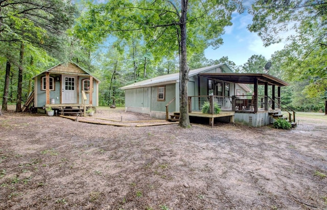 164 Roxie Ln, Greers Ferry, AR 72067 - back of house with an outdoor structure and a wooden deck