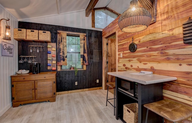 164 Roxie Ln, Greers Ferry, AR 72067 - bar area featuring wooden walls, black microwave, and light wood-style flooring