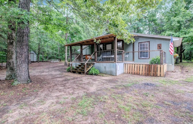 164 Roxie Ln, Greers Ferry, AR 72067 - view of front of house with covered porch and an outdoor structure