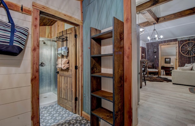 164 Roxie Ln, Greers Ferry, AR 72067 - bathroom with a stall shower, wood finished floors, beamed ceiling, and a chandelier