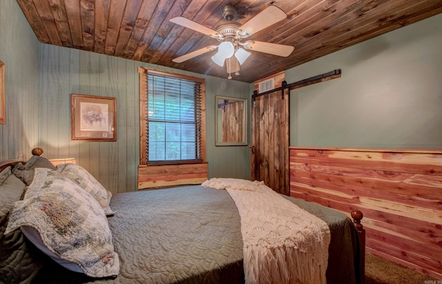 164 Roxie Ln, Greers Ferry, AR 72067 - bedroom featuring wood ceiling, a barn door, carpet floors, wood walls, and ceiling fan
