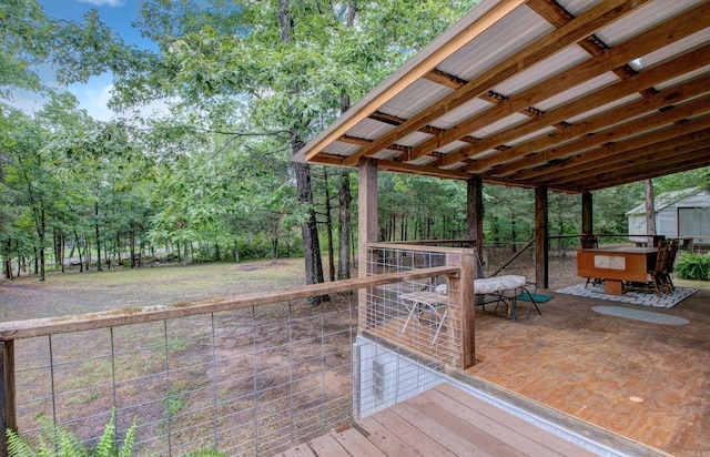 164 Roxie Ln, Greers Ferry, AR 72067 - deck with outdoor dining space, an outdoor structure, and view of wooded area