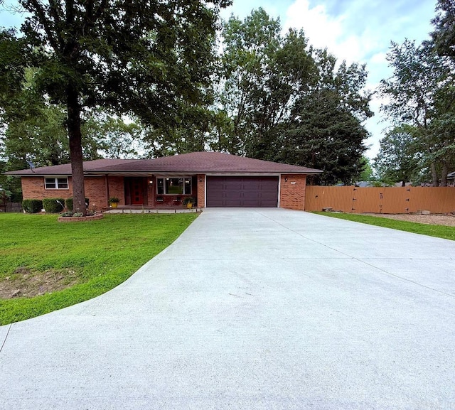 1711 Lonoke Rd, Mountain Home, AR 72653 - ranch-style house with an attached garage, concrete driveway, and brick siding