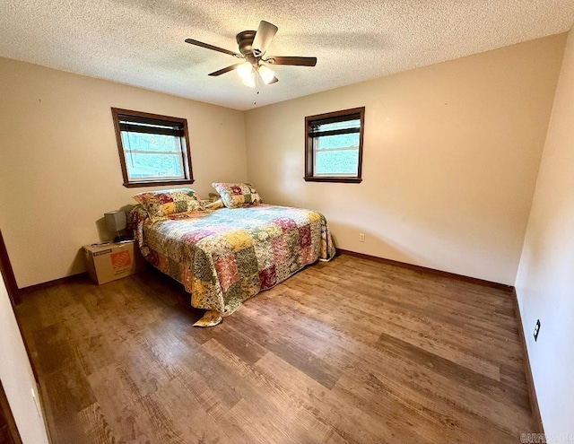 1711 Lonoke Rd, Mountain Home, AR 72653 - bedroom featuring wood finished floors, a textured ceiling, and a ceiling fan