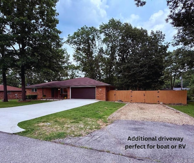1711 Lonoke Rd, Mountain Home, AR 72653 - single story home with a gate, brick siding, concrete driveway, and a garage
