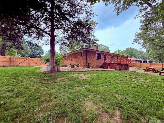 1711 Lonoke Rd, Mountain Home, AR 72653 - rear view of property with a chimney, a fenced backyard, a deck, and brick siding