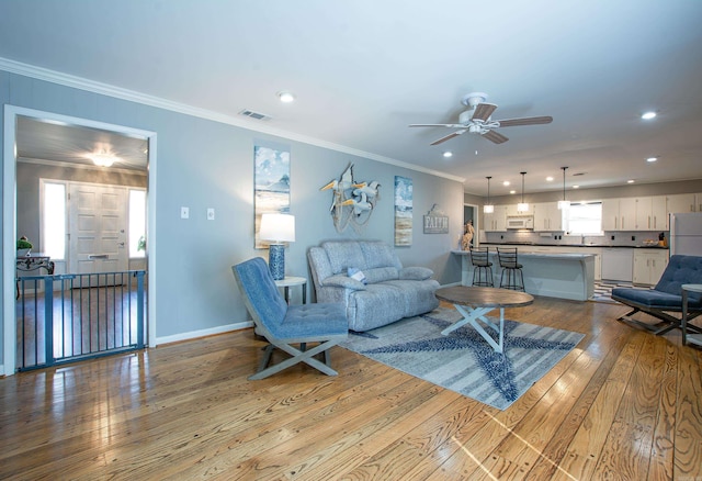 3 Sonata Trl, Little Rock, AR 72205 - living room with wood-type flooring, ceiling fan, recessed lighting, and ornamental molding