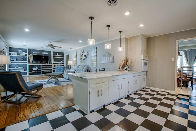 3 Sonata Trl, Little Rock, AR 72205 - kitchen featuring dark floors, a peninsula, ornamental molding, a ceiling fan, and oven