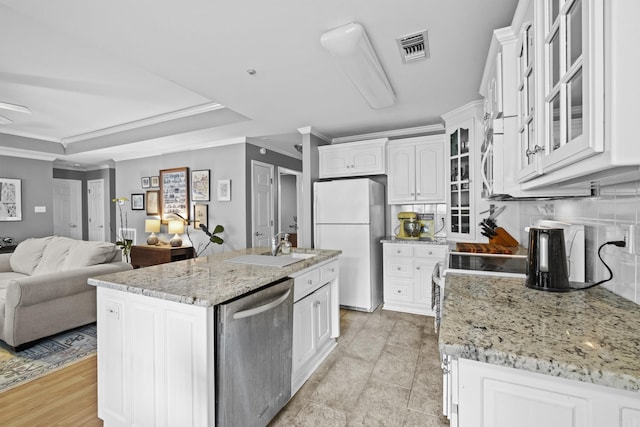 1323 Starfield, North Little Rock, AR 72116 - kitchen with dishwasher, freestanding refrigerator, ornamental molding, white cabinets, and light stone counters