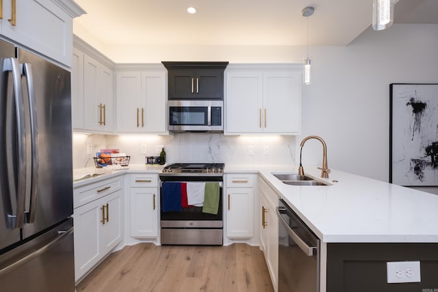11325 Jamestown Dr, Little Rock, AR 72211 - kitchen featuring appliances with stainless steel finishes, a peninsula, light wood-type flooring, light countertops, and tasteful backsplash