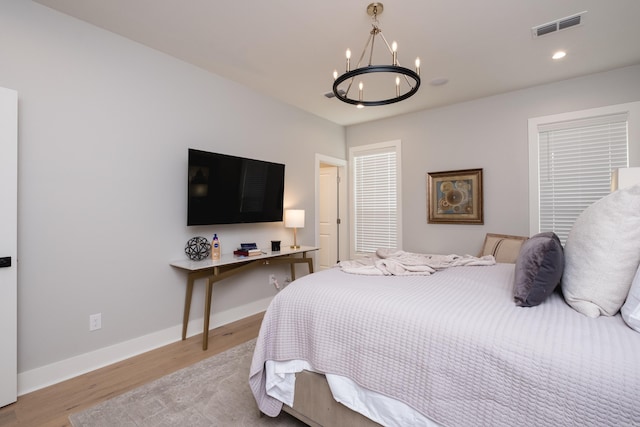 11325 Jamestown Dr, Little Rock, AR 72211 - bedroom featuring a chandelier, light wood-type flooring, and recessed lighting