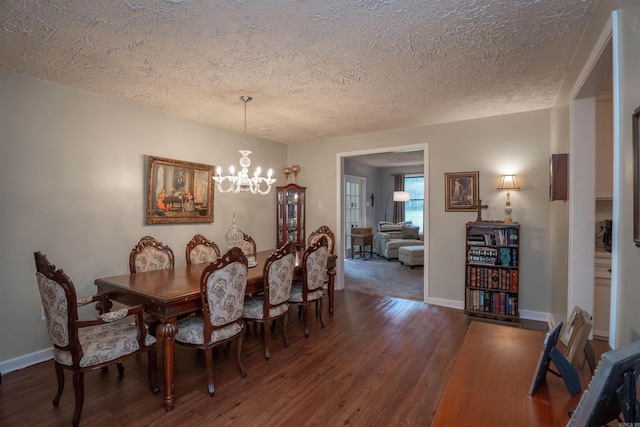 3209 Jack Mann Rd, Little Rock, AR 72210 - dining space featuring a textured ceiling, wood finished floors, and a chandelier