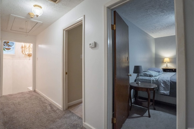 3209 Jack Mann Rd, Little Rock, AR 72210 - hallway featuring a textured ceiling, attic access, and carpet