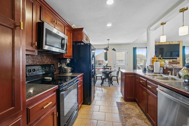 1905 Highgrove Rd, Harrison, AR 72601 - kitchen with black appliances, dark countertops, decorative backsplash, stone tile flooring, and hanging light fixtures