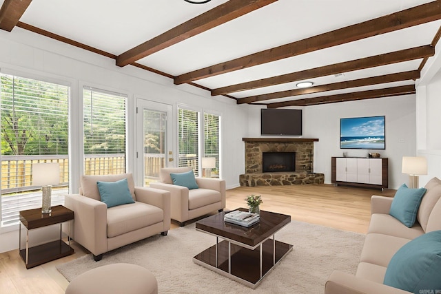 8719 Evergreen Dr, Little Rock, AR 72227 - living room with wood finished floors, beam ceiling, and a stone fireplace