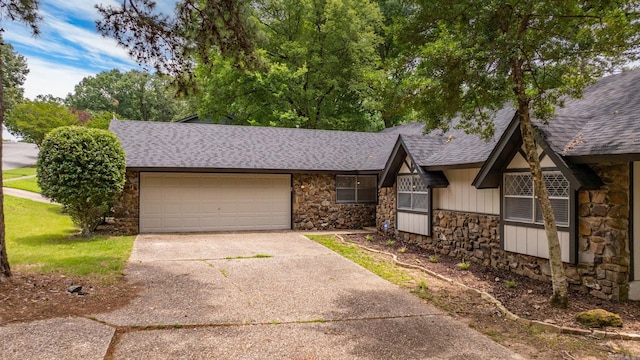 8719 Evergreen Dr, Little Rock, AR 72227 - view of front of house with stone siding, roof with shingles, driveway, and an attached garage