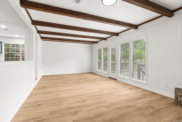 8719 Evergreen Dr, Little Rock, AR 72227 - unfurnished room featuring beam ceiling, healthy amount of natural light, and light wood-style flooring