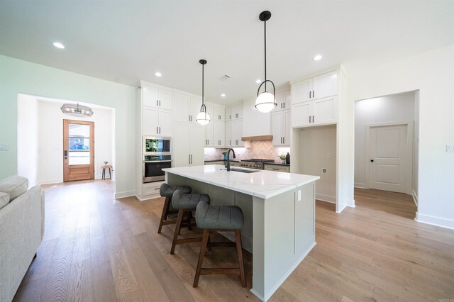 14509 Stonebrook Ln, Maumelle, AR 72113 - kitchen featuring stainless steel oven, tasteful backsplash, white cabinetry, built in microwave, and recessed lighting