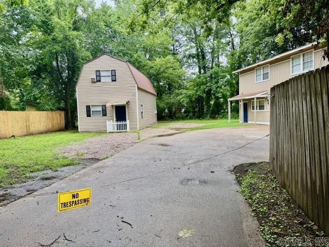 1520 S Main St, Malvern, AR 72104 - garage with driveway and view of scattered trees