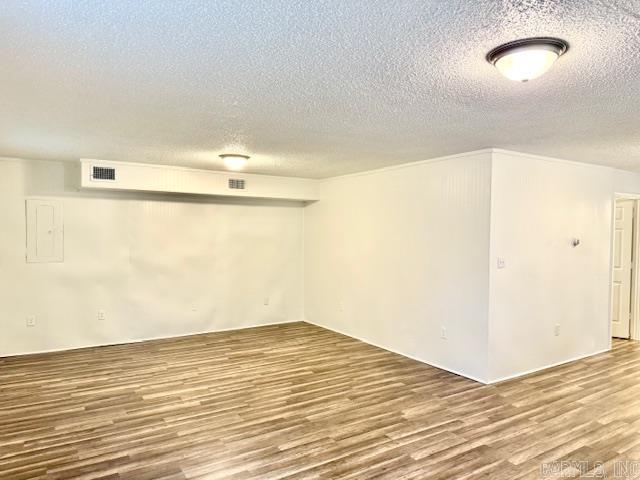 1520 S Main St, Malvern, AR 72104 - finished below grade area with wood finished floors, a textured ceiling, and electric panel