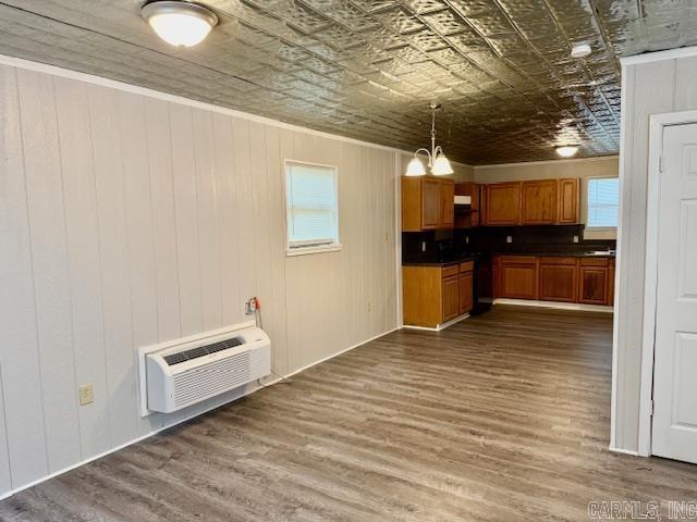 1520 S Main St, Malvern, AR 72104 - kitchen with an ornate ceiling, a wall mounted air conditioner, dark countertops, dark wood finished floors, and brown cabinets