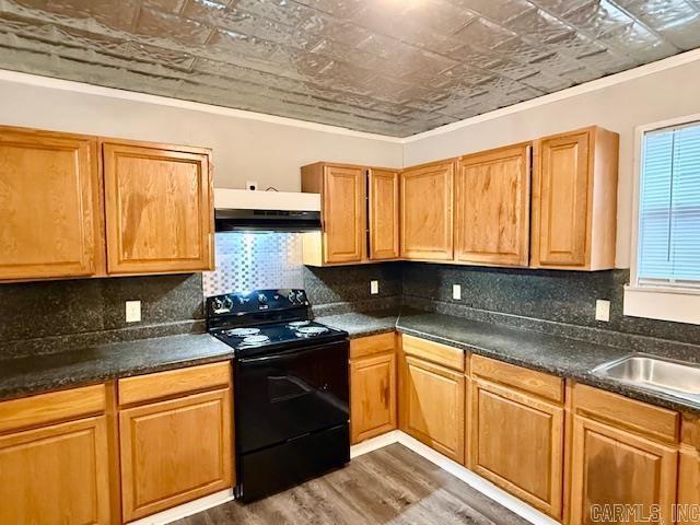 1520 S Main St, Malvern, AR 72104 - kitchen featuring black / electric stove, an ornate ceiling, under cabinet range hood, dark wood finished floors, and dark countertops