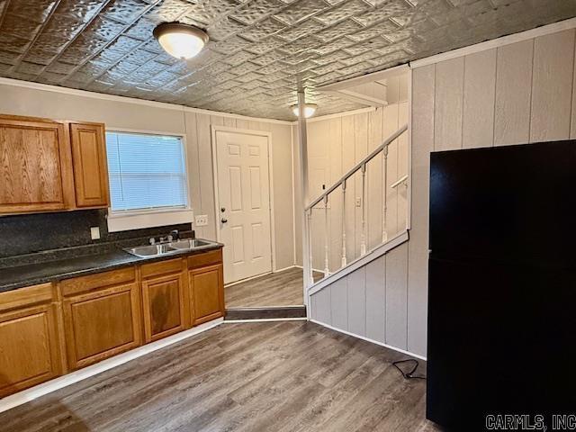 1520 S Main St, Malvern, AR 72104 - kitchen featuring an ornate ceiling, dark countertops, brown cabinets, wood finished floors, and crown molding
