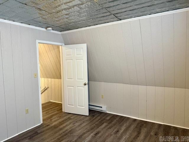 1520 S Main St, Malvern, AR 72104 - empty room with a baseboard heating unit, wood finished floors, and wood walls