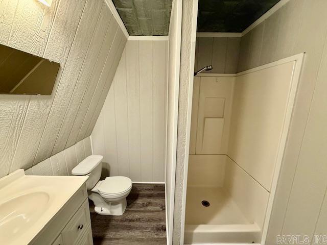 1520 S Main St, Malvern, AR 72104 - full bath with vanity, a shower stall, wood finished floors, and wooden walls