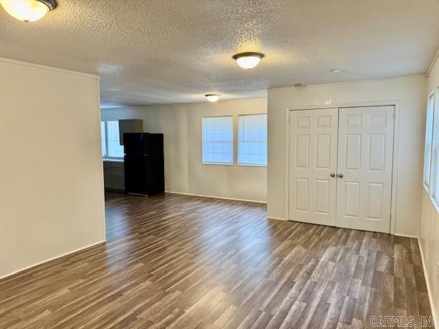 1520 S Main St, Malvern, AR 72104 - unfurnished room with dark wood-style flooring and a textured ceiling