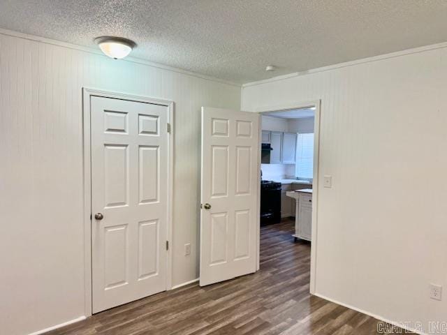 1520 S Main St, Malvern, AR 72104 - empty room with crown molding, a textured ceiling, and dark wood finished floors