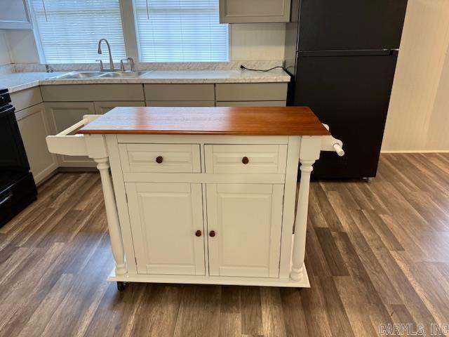 1520 S Main St, Malvern, AR 72104 - kitchen with freestanding refrigerator, wood counters, dark wood finished floors, and range