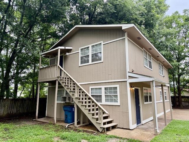 1520 S Main St, Malvern, AR 72104 - rear view of property featuring stairs, cooling unit, and view of wooded area