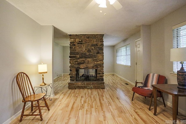 42 Bradford, Little Rock, AR 72227 - living area with wood finished floors, a ceiling fan, and a fireplace