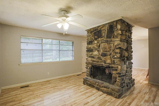 42 Bradford, Little Rock, AR 72227 - unfurnished living room with a ceiling fan, wood finished floors, a textured ceiling, and a fireplace