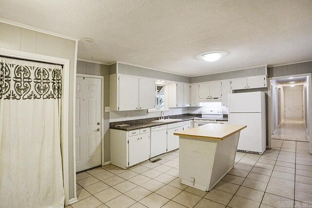42 Bradford, Little Rock, AR 72227 - kitchen featuring white appliances, ornamental molding, white cabinets, light tile patterned flooring, and a textured ceiling