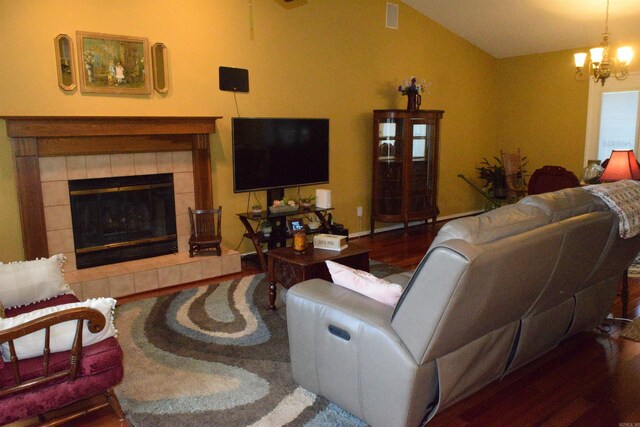 6 Lendl Loop, Little Rock, AR 72210 - living area featuring wood finished floors, a chandelier, lofted ceiling, and a tiled fireplace