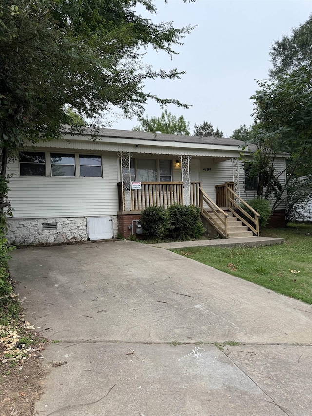 4704 Massie St, North Little Rock, AR 72118 - view of front facade featuring covered porch and crawl space