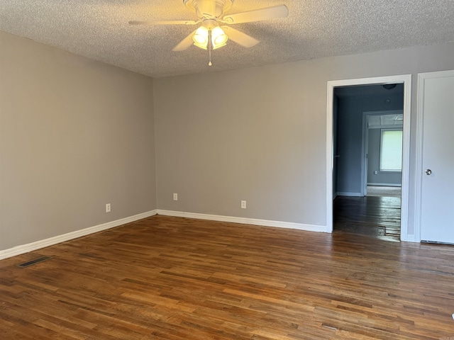 4704 Massie St, North Little Rock, AR 72118 - spare room featuring dark wood-type flooring, a textured ceiling, and a ceiling fan