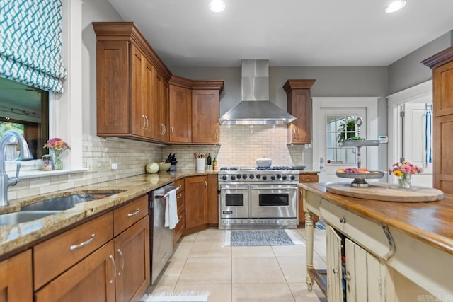 1116 Kavanaugh Blvd, Little Rock, AR 72205 - kitchen featuring wall chimney exhaust hood, appliances with stainless steel finishes, light tile patterned floors, tasteful backsplash, and brown cabinetry