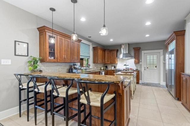 1116 Kavanaugh Blvd, Little Rock, AR 72205 - kitchen featuring wall chimney range hood, brown cabinets, healthy amount of natural light, and recessed lighting
