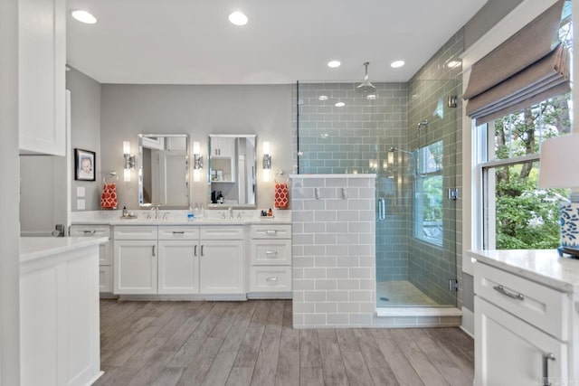 1116 Kavanaugh Blvd, Little Rock, AR 72205 - bathroom featuring vanity, a shower stall, wood finished floors, and recessed lighting