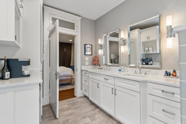 1116 Kavanaugh Blvd, Little Rock, AR 72205 - full bathroom with connected bathroom, double vanity, and wood finished floors