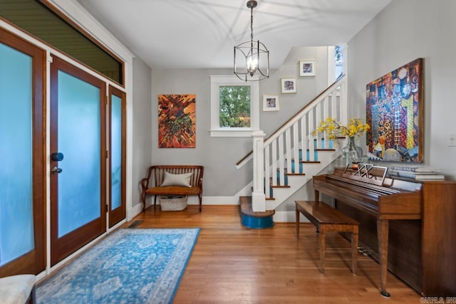 1116 Kavanaugh Blvd, Little Rock, AR 72205 - entrance foyer featuring a chandelier, stairway, and wood finished floors